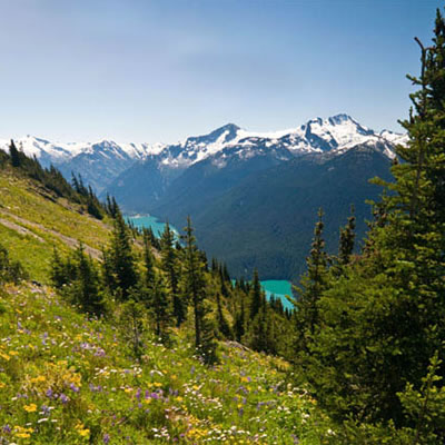 Views from Riverside RV Resort include distant mountains and a lake in the foreground. 