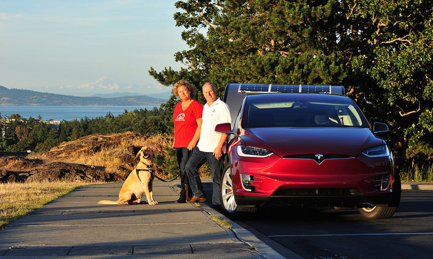 Rolf Oetter and Silke Sommerfeld standing outside of their Telsa Model S.