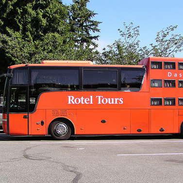 A red Das Rollende Hotel parked as an RV