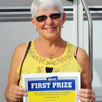 Donna Leslie with her winner's certificate and RV.