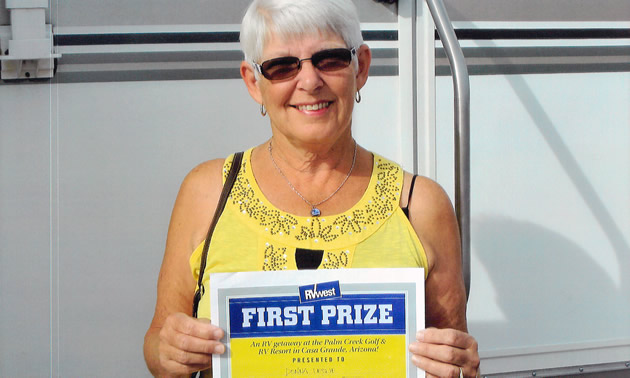 Donna Leslie with her winner's certificate and RV.