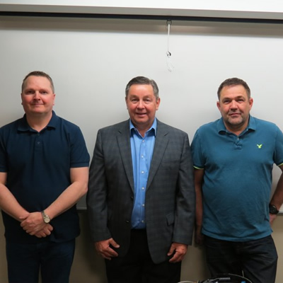 RVDA of Alberta Executive Director Dan Merkowsky (centre) and SAIT RV techician instructors.