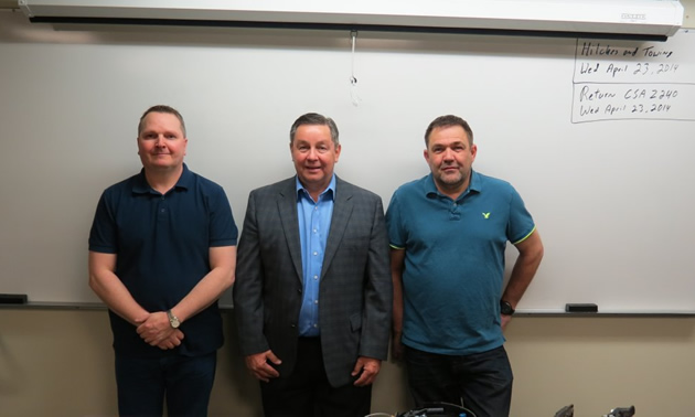 RVDA of Alberta Executive Director Dan Merkowsky (centre) and SAIT RV techician instructors.