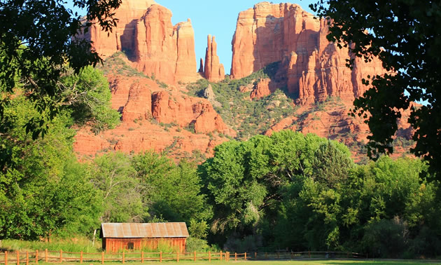Picture of cabin with sandstone mountains in background. 