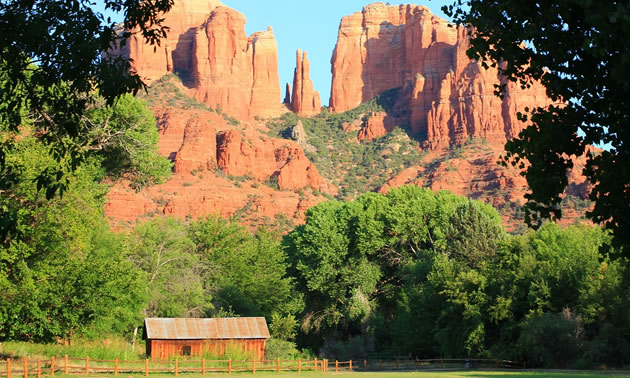 Picture of cabin with sandstone mountains in background.
