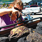 woman taking a photo of a truck full of coal in Sparwood BC