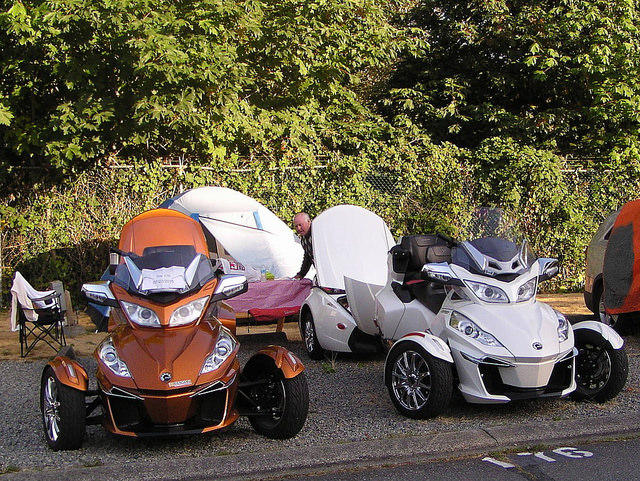 Gleaming bronze and creamy-white version Spyders sitting outside of a tent in Vancouver