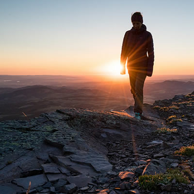 Girl silhouetted against setting sun. 