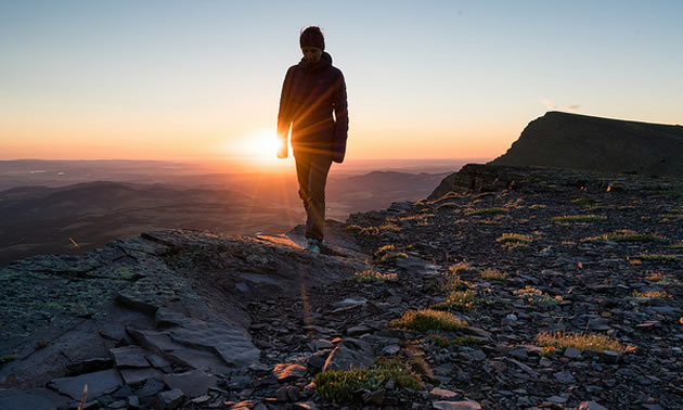 Girl silhouetted against setting sun. 