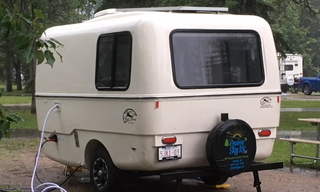 White vintage-looking Boler-style trailer. 