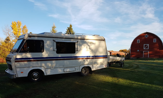 A 1982 Triple E motorhome, parked in a field. 