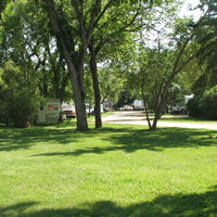 Green lawn and shade trees at River Park Campground in Moose Jaw, SK