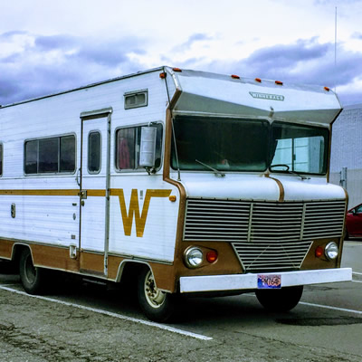 Winnebago Brave parked in parking lot. 