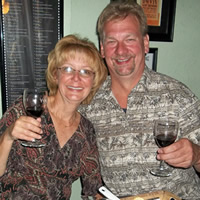 Sitting senior couple raise glasses of wine in a toast