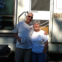 Jim and Marianne Ziegler standing in front of their RV