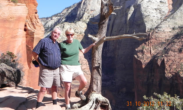 Senior couple on a hiking trail among cliffs