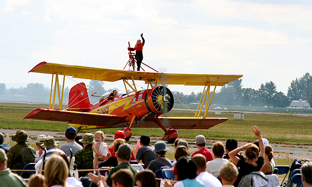 person standing on top of an aircraft at the Abbotsford Air Show