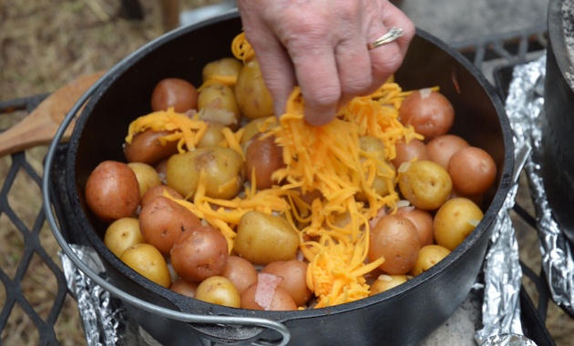 Adding the cheese to the tender potatoes. 