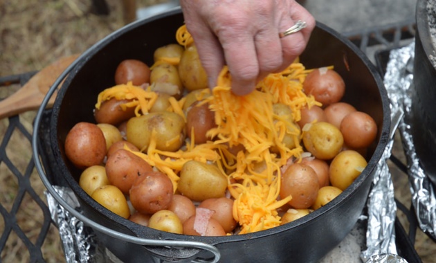 Adding the cheese to the tender potatoes.