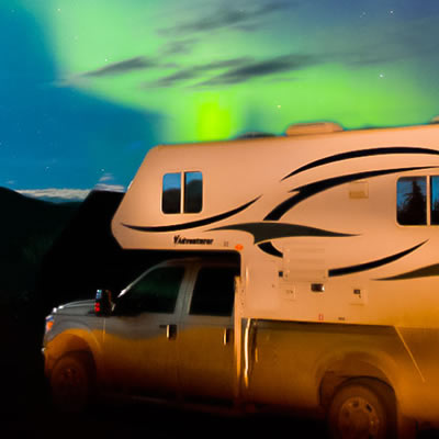 Picture of RV with aurora in background. 