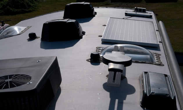 This is the top of the author's trailer, showing the air conditioner, solar panel and vents with covers.