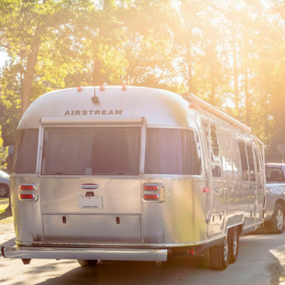 Truck towing an Airstream trailer. 