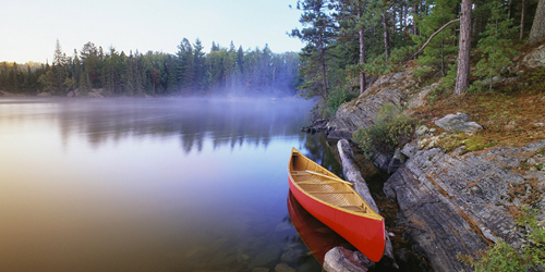 A canoe rests on Pinetree Lake, Algonquin Provincial Park, Ontario