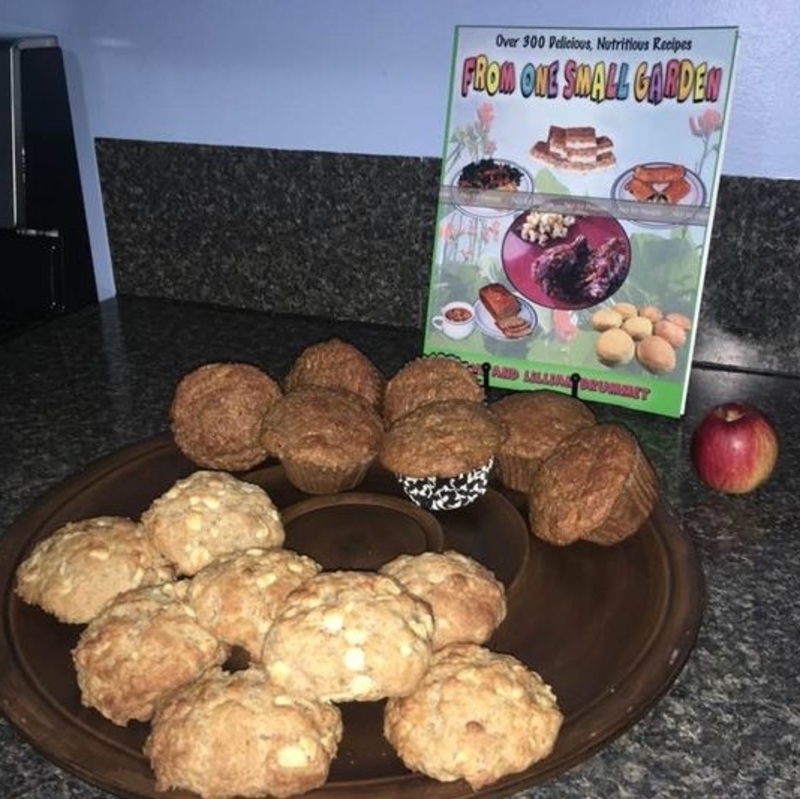 muffins on a plate in front of a cook book
