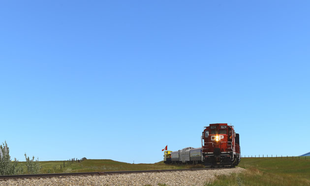 Train, with brilliant blue sky.