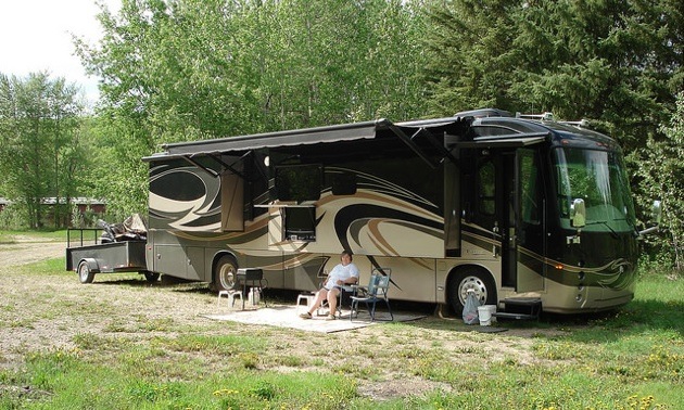 Grace Christian sitting outside their 2012 Integra Aspire Class A Diesel Pusher with four slides.