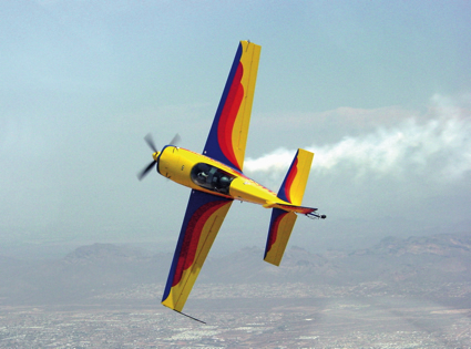 A aerobatic airplanes twists through the air.