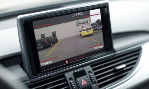 A backup camera mounted on a dashboard