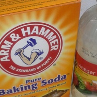 A photo of a box of baking soda and a bottle of vinegar