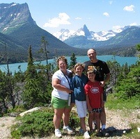 The Srubowich family with their backs to a view at the Going-to-the sun Road in Glacier Naional Park, Montana. 