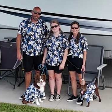 The Banks family in matching floral shirts, including their dog