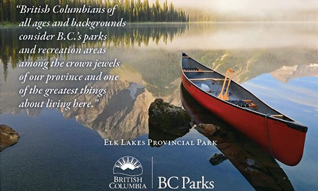 Picture of BC park, with red canoe sitting in fog-shrouded lake, mountain in background. 