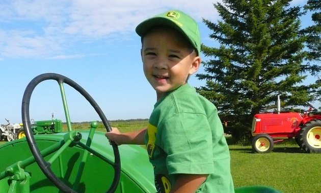 child riding a tractor in Beaver County's agri tourism event