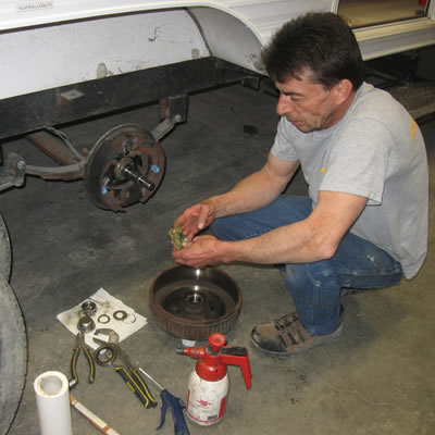 Lloyd Panchuk, an RV service technician with Runners RV in Cranbrook, B.C., works on repacking wheel bearings.
