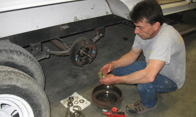 Lloyd Panchuk, an RV service technician with Runners RV in Cranbrook, B.C., works on repacking wheel bearings.