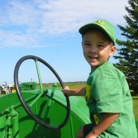 child riding a tractor in Beaver County's agri tourism event