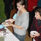 People holding plates of food.