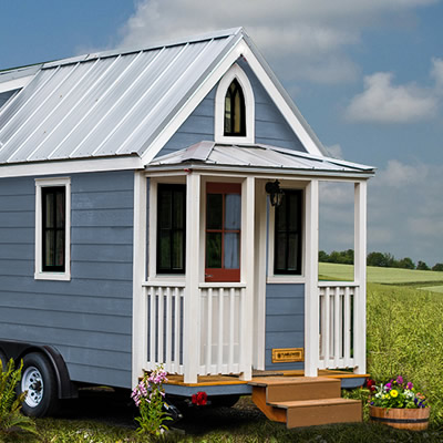 Picture of blue tiny house RV unit. 