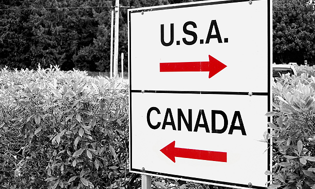 sign with USA and Canada with arrows pointing each way