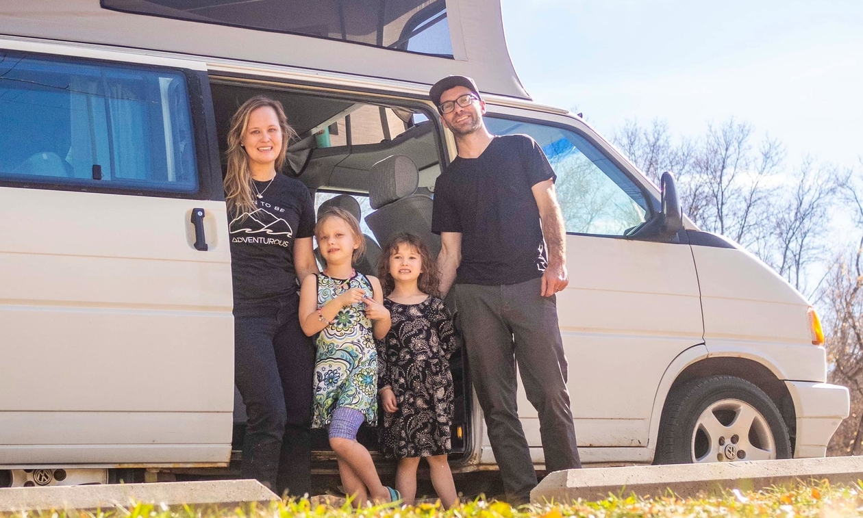 Annika, Cam and their two daughters in front of a white van