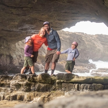 The Mang family standing together during a camping trip