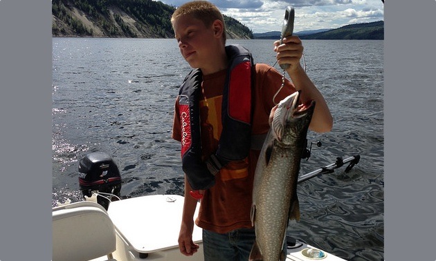Ethan Cox showing off his catch from Williston Lake near Mackenzie.