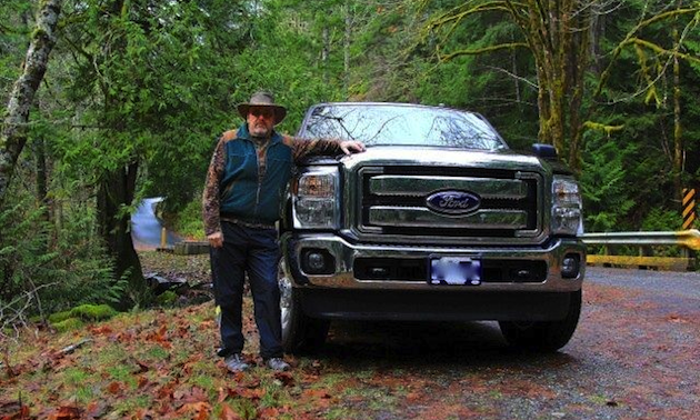 Man standing beside a truck