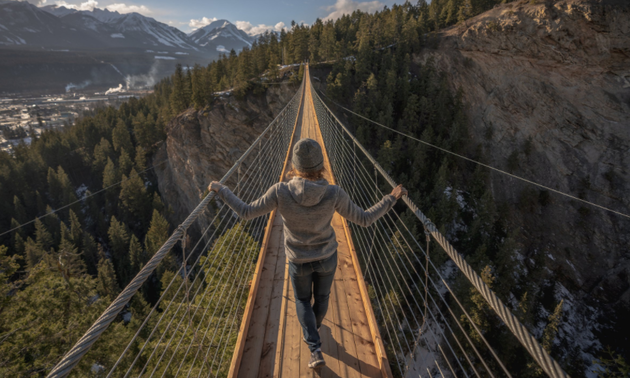 lady walking on a suspension bridge