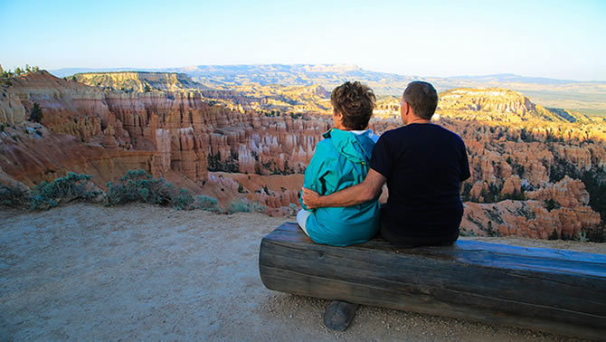 Picture of two people sitting on bench at Bryce Canyon, Utah. 