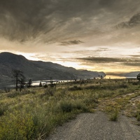 Summer sunrise on Kamloops lake. this is the BC desert country, driving from Cache Creek on Highway 97 there was lots of rain during the spring so the sage and grass were still green. the yellow flowers were still blooming as well. 